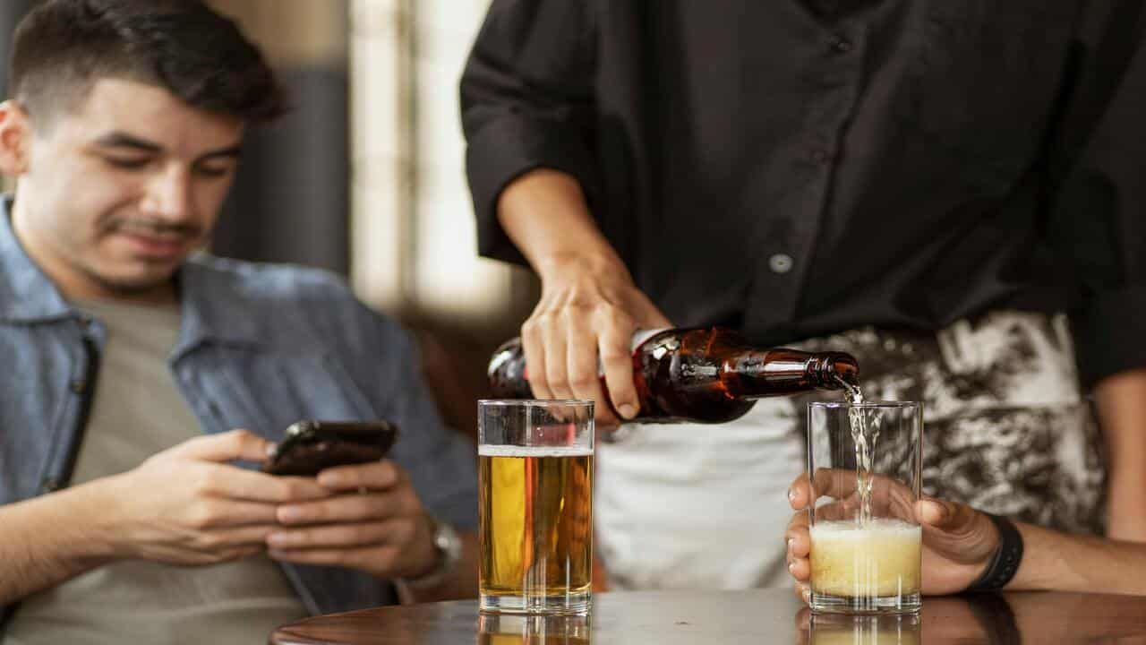 A man texting in a restaurant