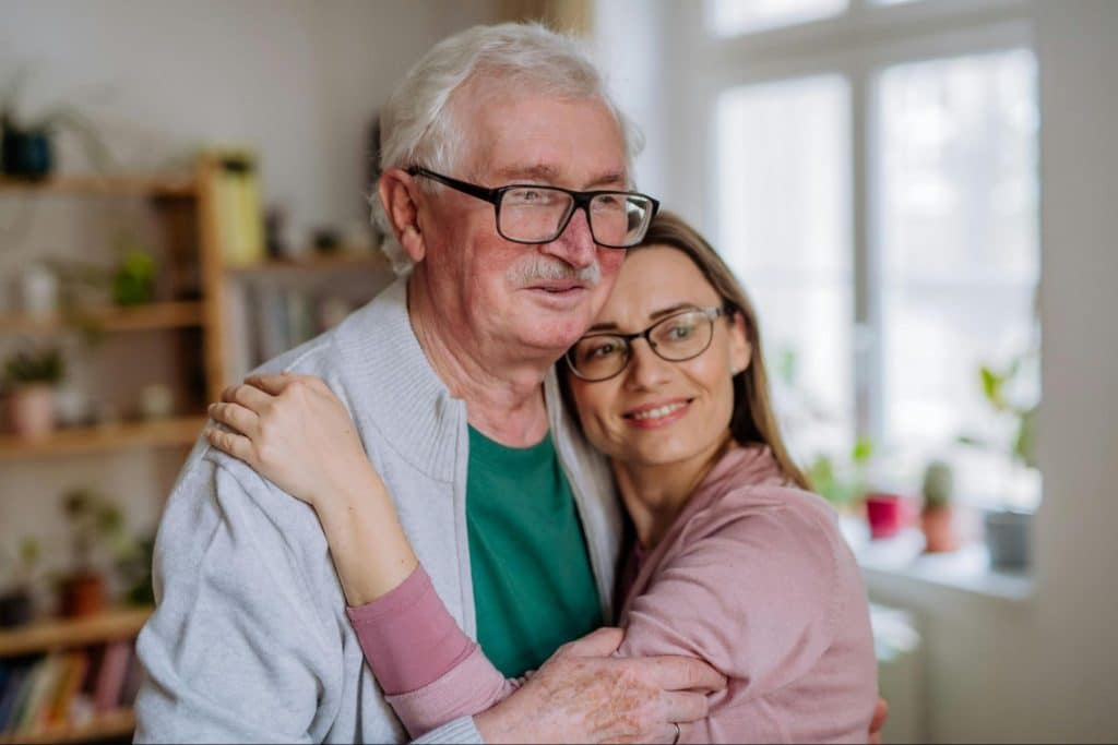 A woman hugging a man