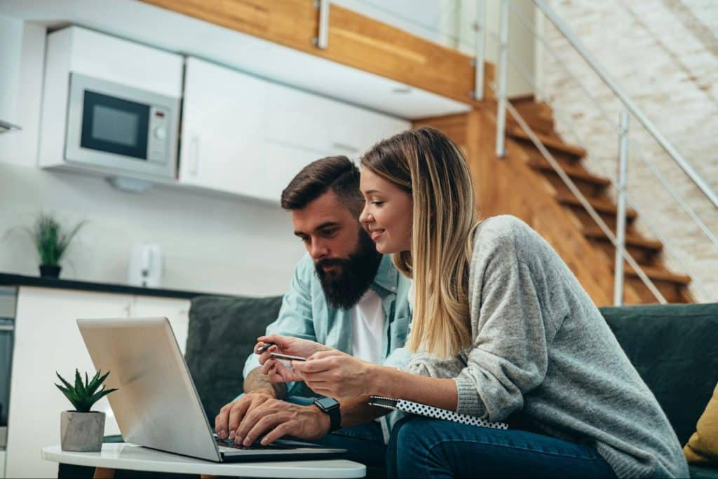 A man and woman having a casual talk about laptop