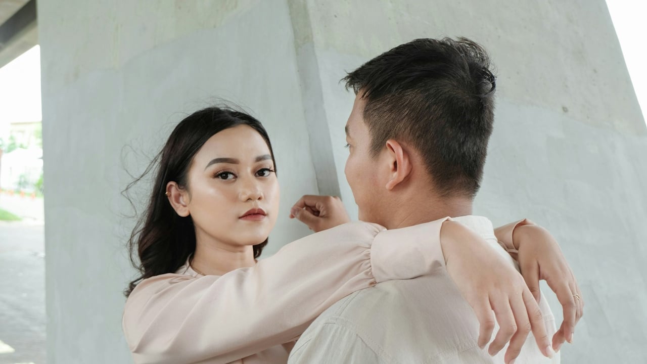 A man and a woman standing with each other.