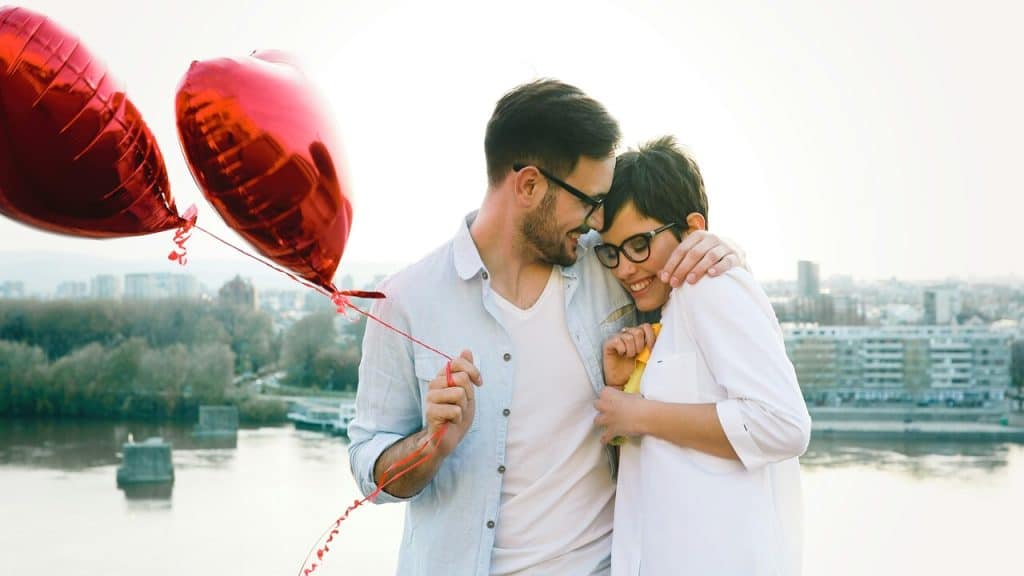 A man surprising his girlfriend with balloons