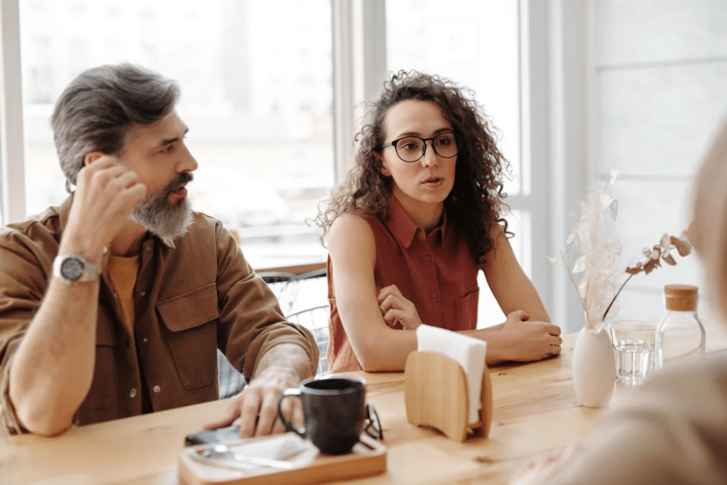 A Man and Woman Sitting at the Table Together
