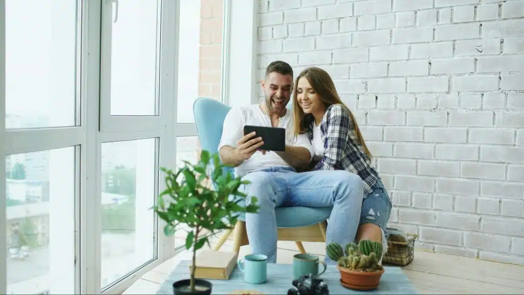 A man and woman looking at the tablet