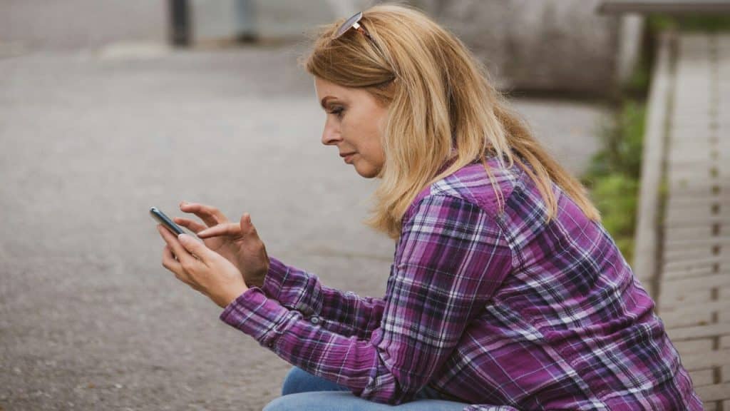 A mature woman looking at her phone