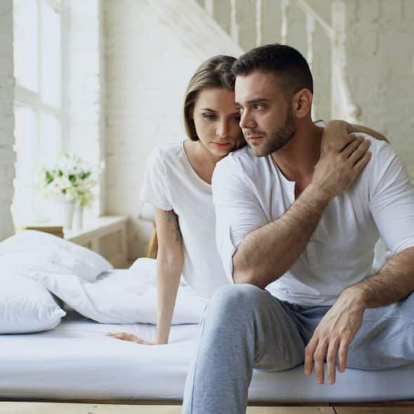 A couple looking upset at home