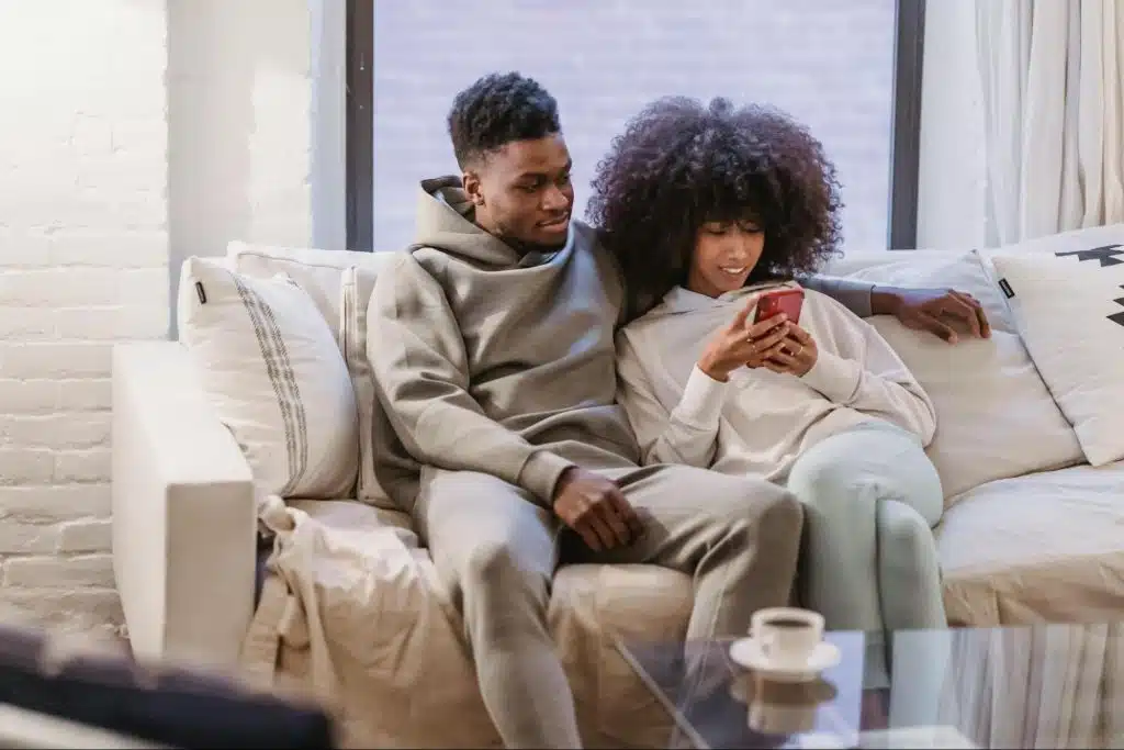 A man and woman sitting at the couch