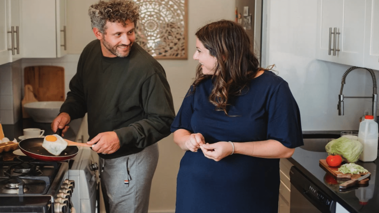 A couple talking in the kitchen