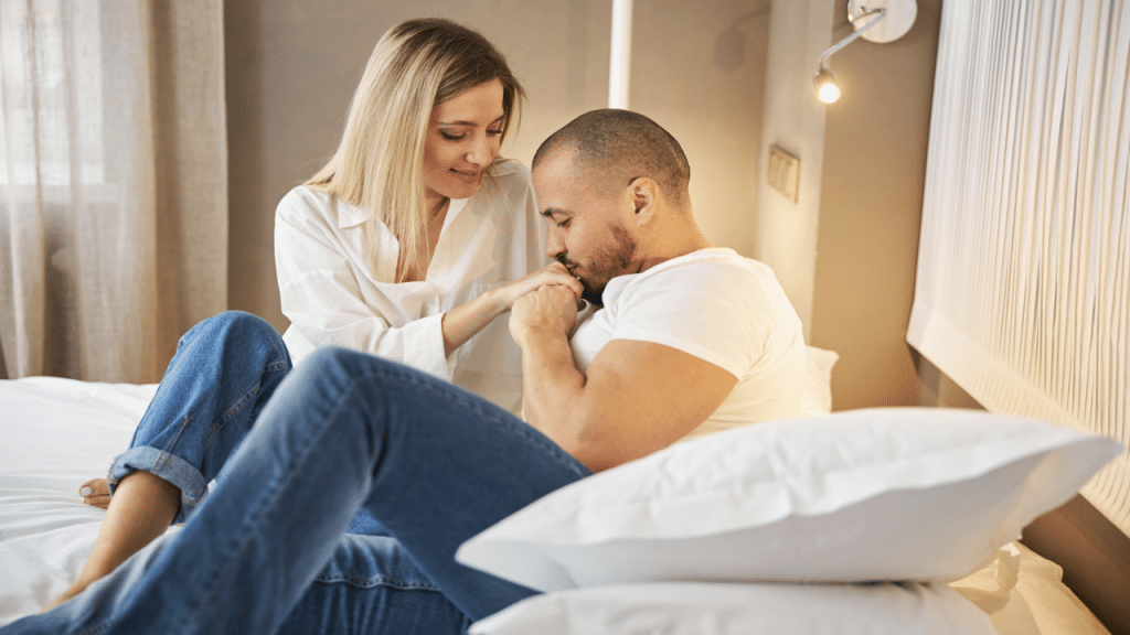 A man kissing his wife’s hand