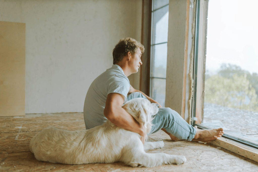 Man sitting on the floor with a dog