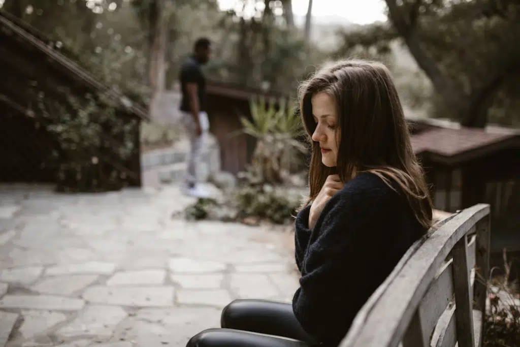 A woman crying on a bench