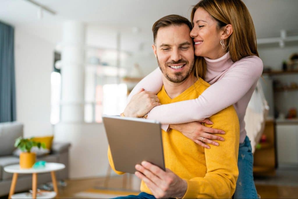 A woman hugging a man