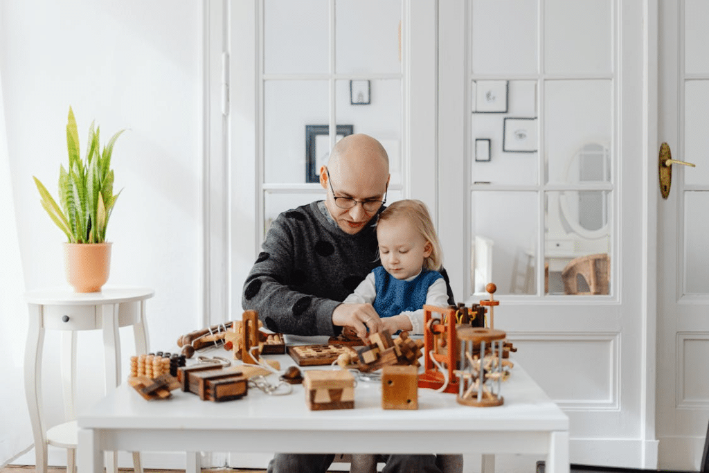 A Man Talking to His Daughter while Playing Wooden Toys on the Table