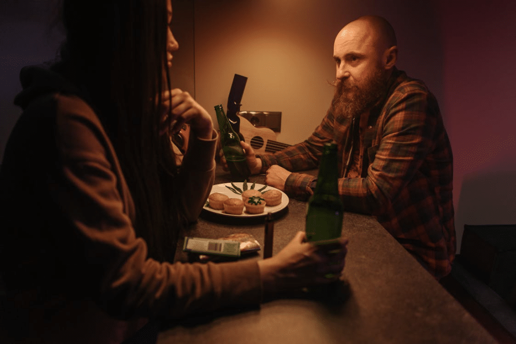 A man and woman holding a beer bottle