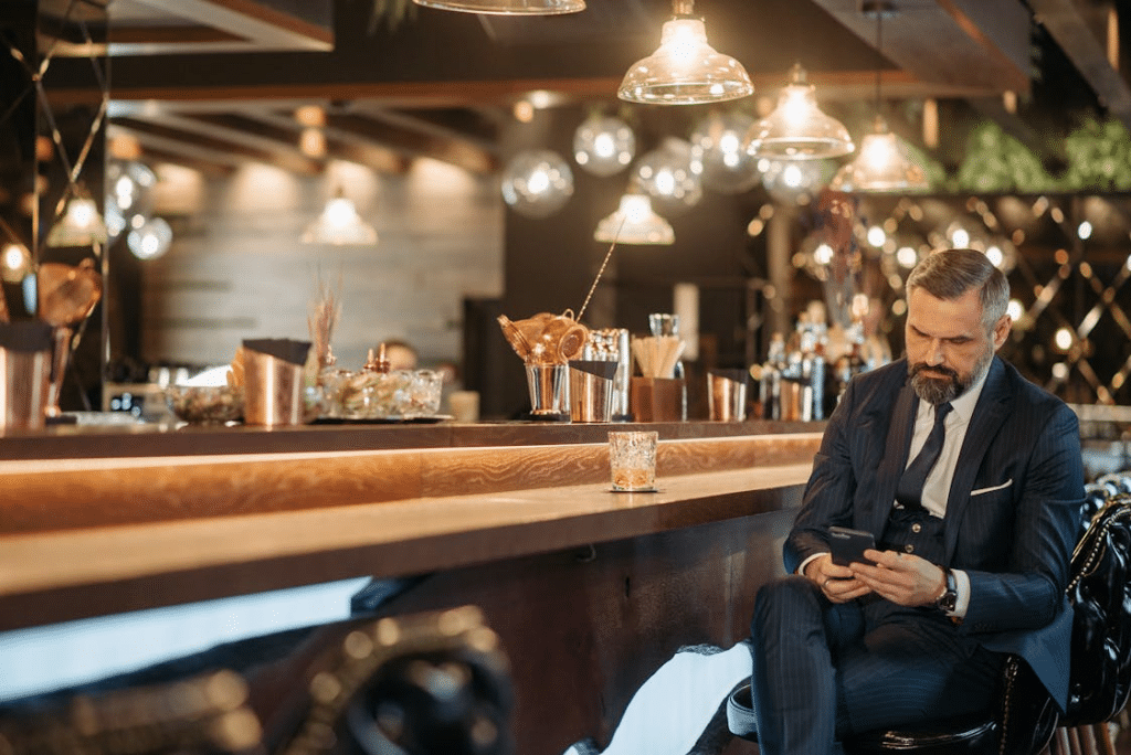 A man in a suit sitting at the bar