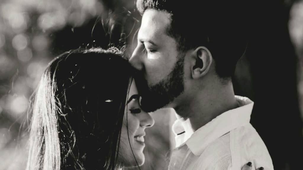 A man and a woman kissing each other.