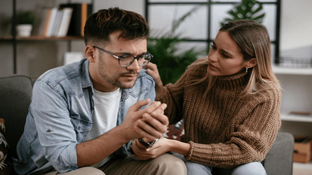 A woman comforting her upset boyfriend
