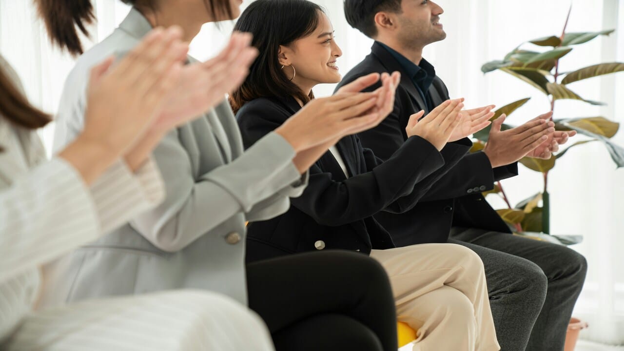 A group of people clapping 