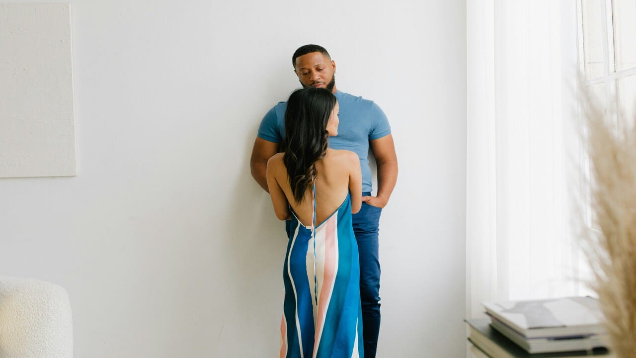 A couple looking sad in the living room