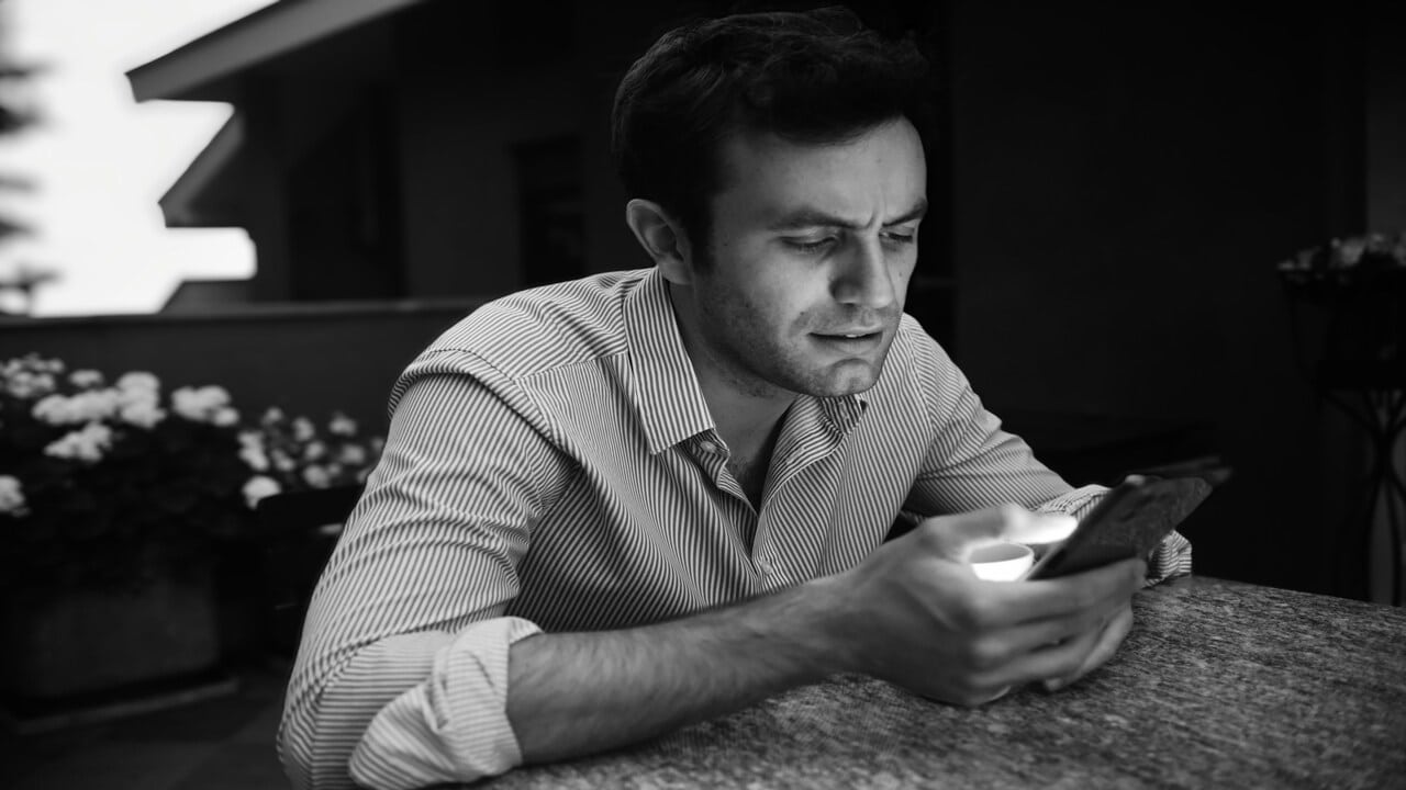 A man looking sad while scrolling