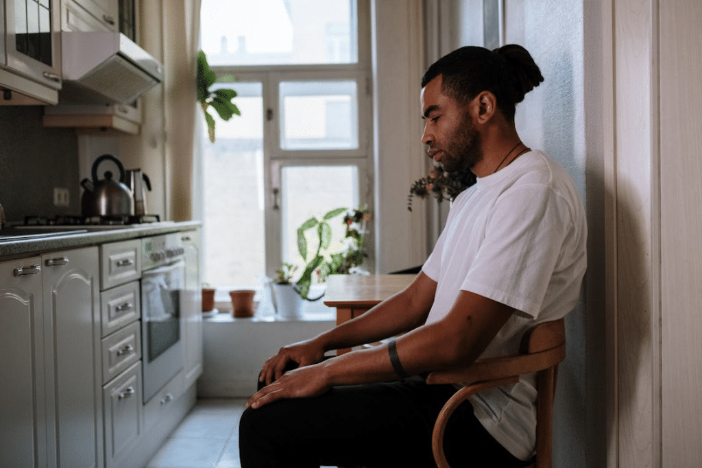 A Man in White Sitting Alone