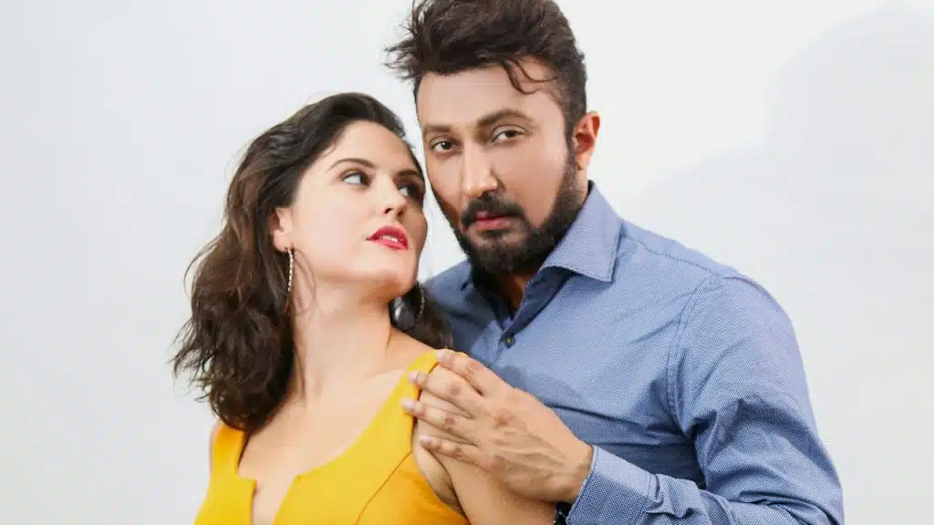 A man holding a woman by her shoulders who is looking at him.