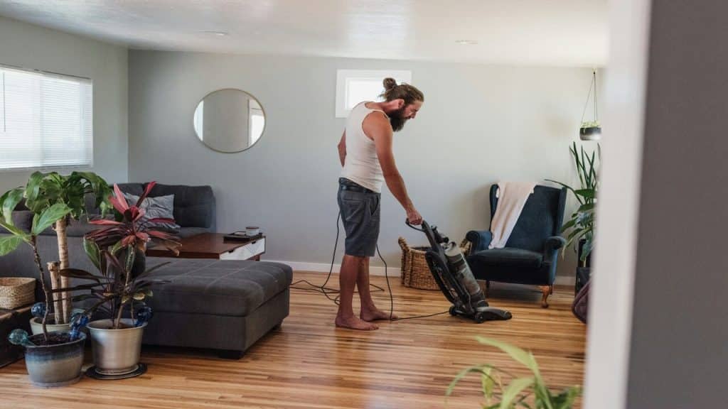 A man vacuuming the living room