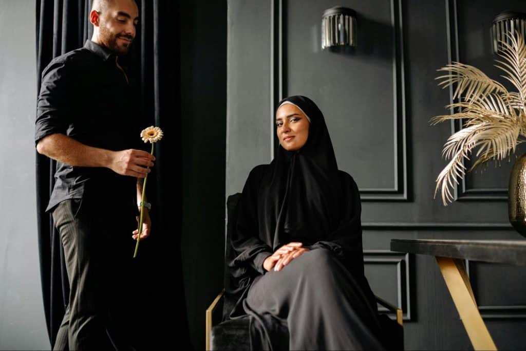 A man giving a flower to woman