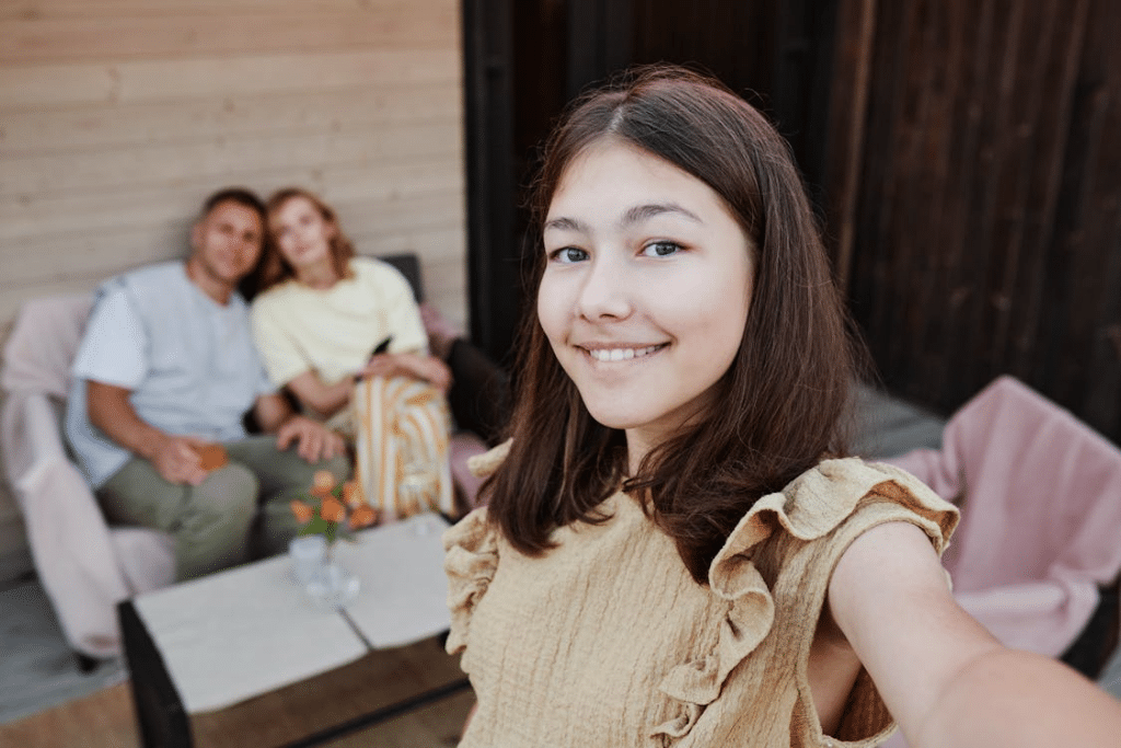 Woman in Beige Top Taking Family Selfie