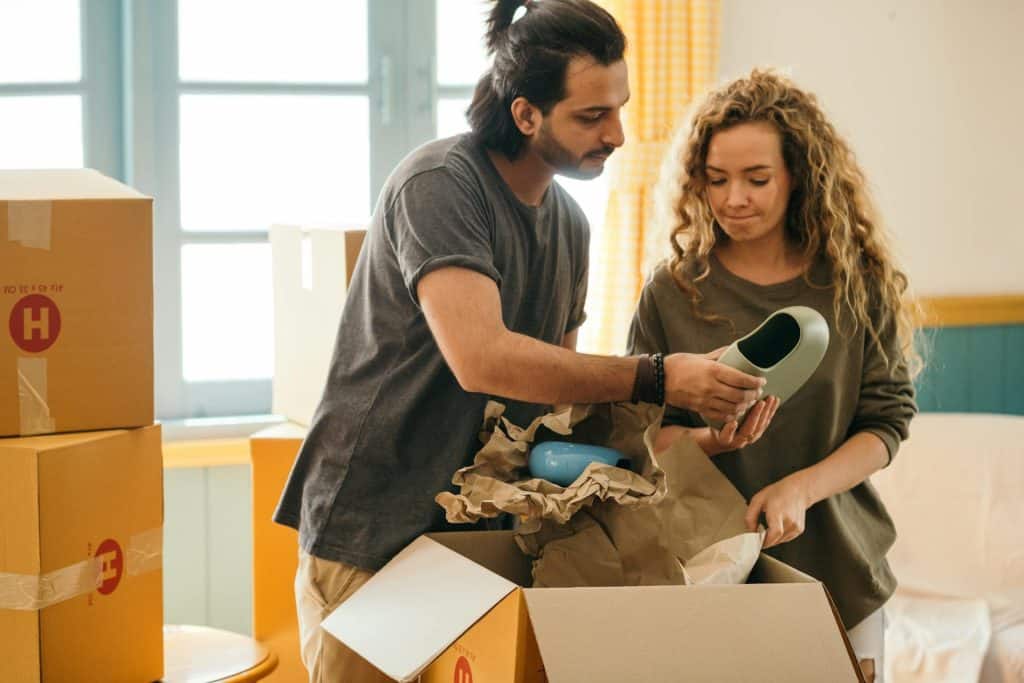 The couple is unpacking the vases after moving in into a new apartment.