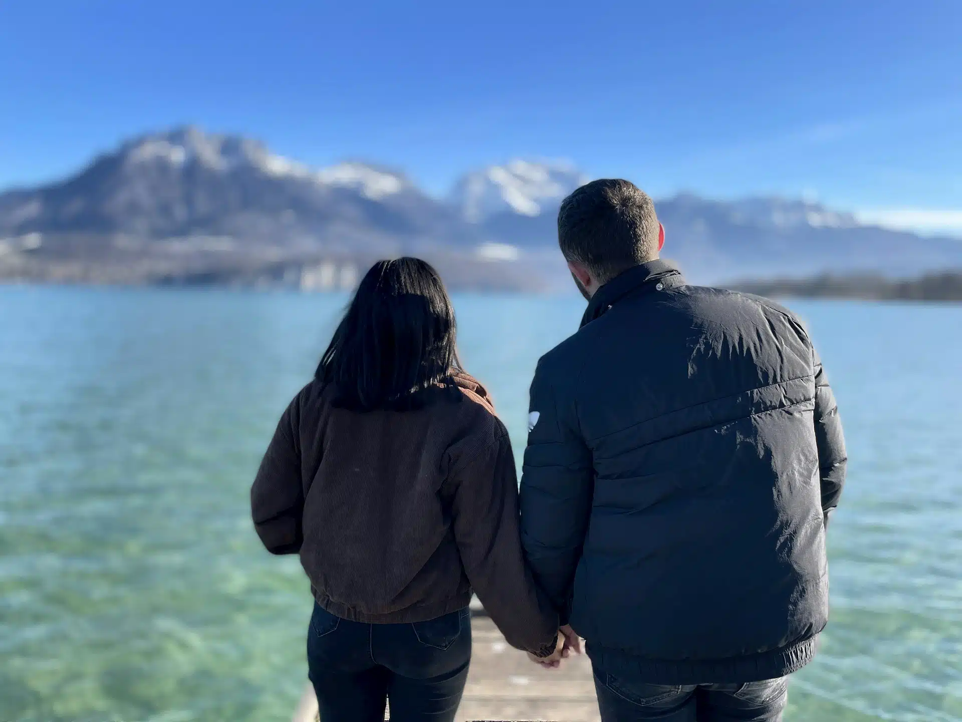 A couple holding hands and looking at a view.