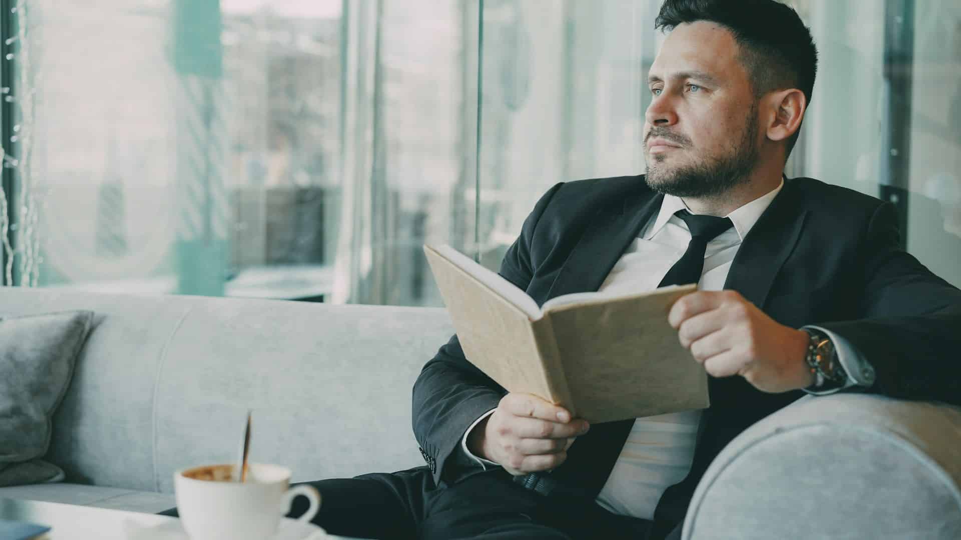 A man sitting on a couch and looking away.