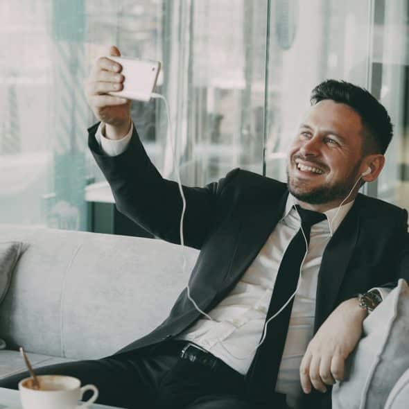 A man on videocall and smiling.