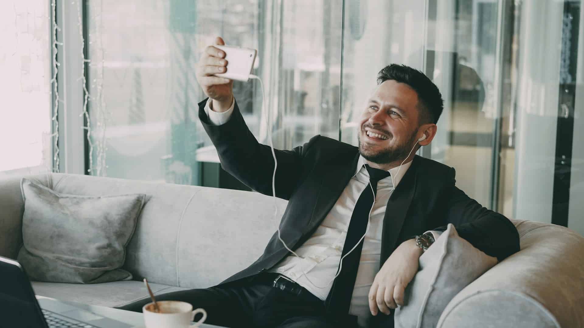 A man on videocall and smiling.