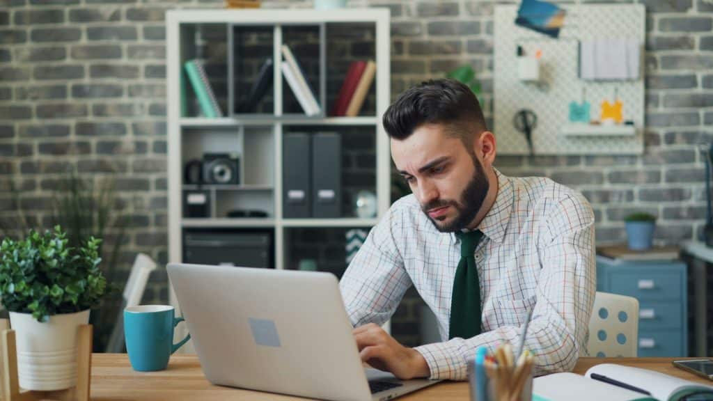 A man looking sadly at the laptop