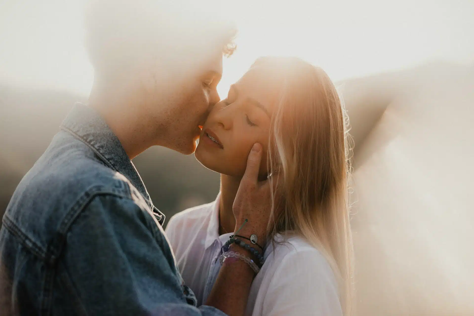 A man kissing a woman's cheek