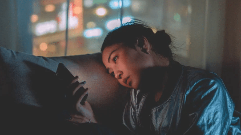 A woman looking sad while texting