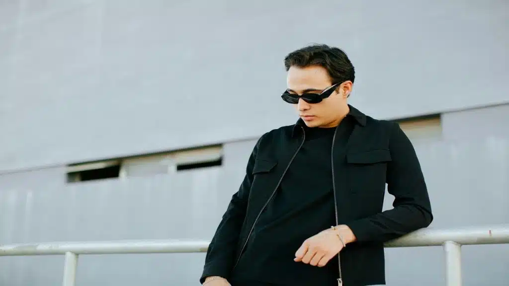 A man wearing sunglasses and black jacket