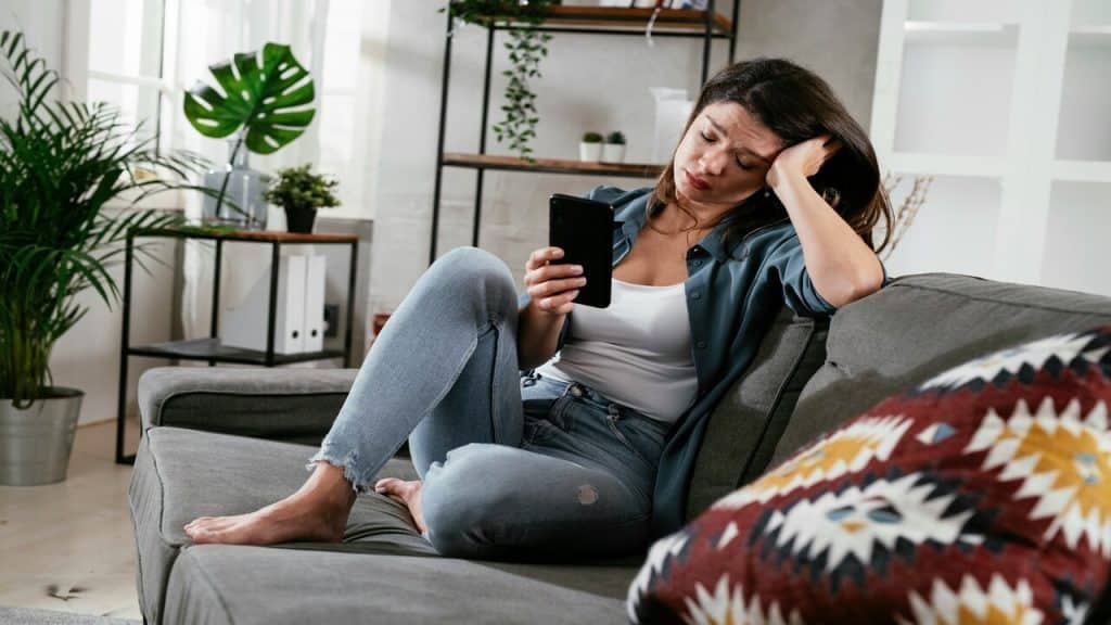 A woman looking upset while texting