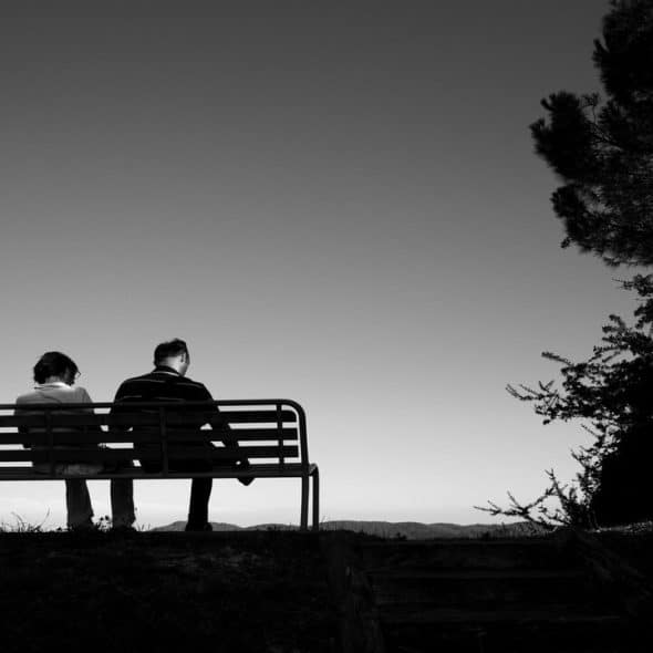 A couple sitting on a bench