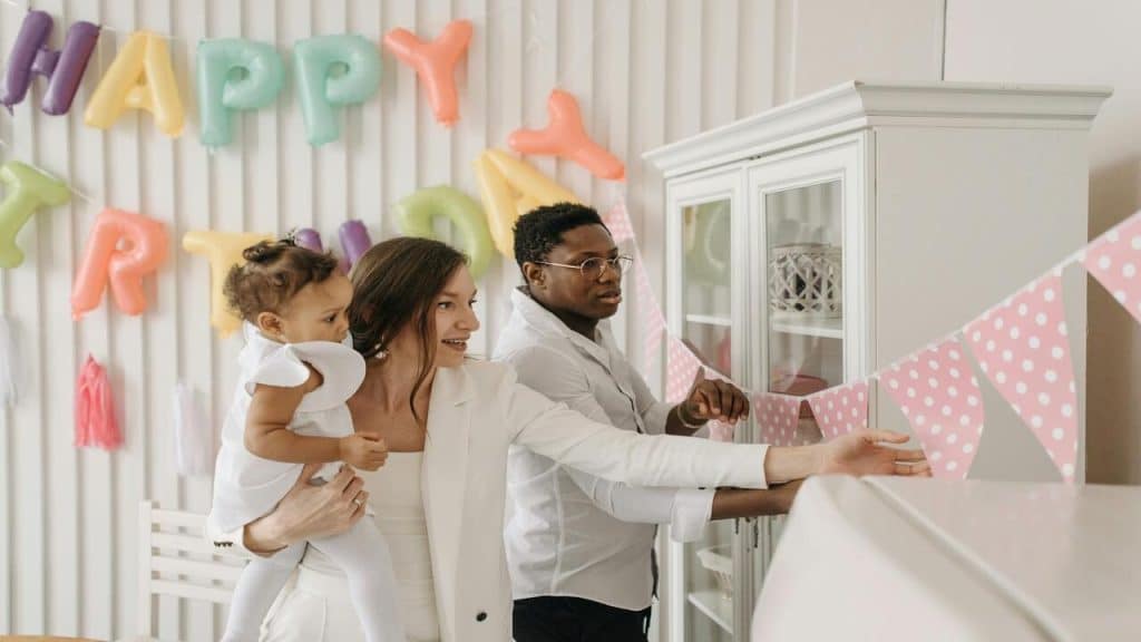 A couple putting up decor in their house 