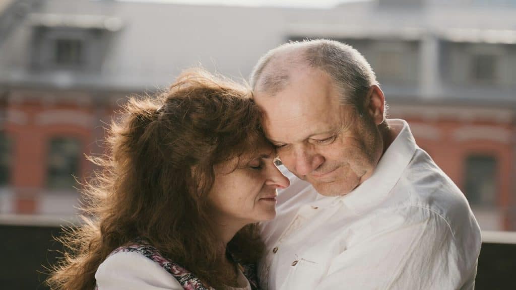 An older couple hugging