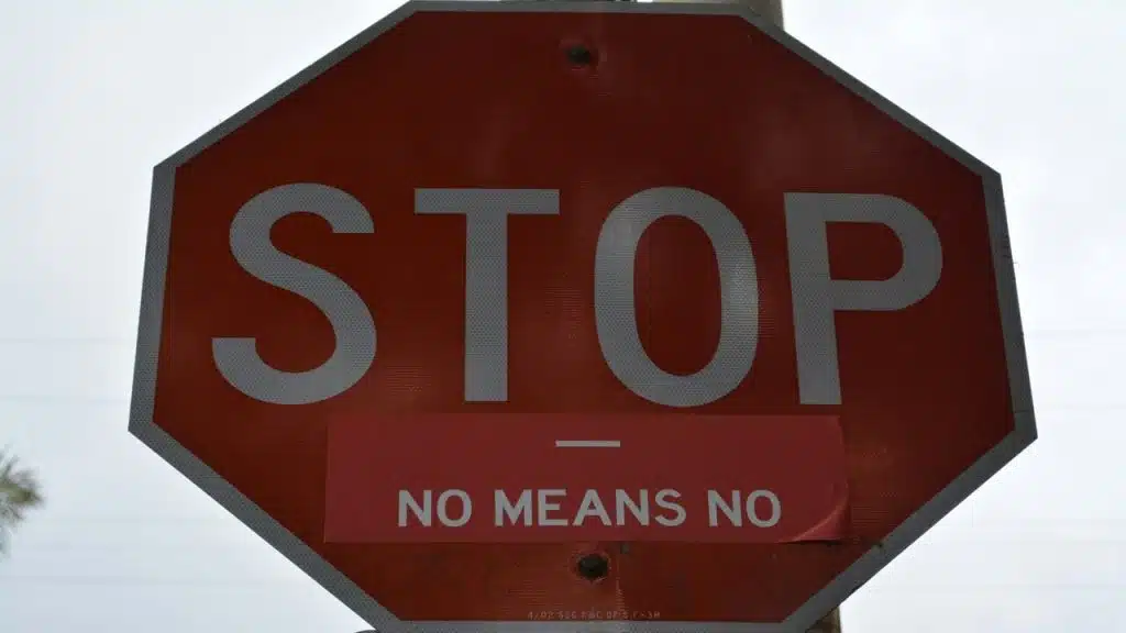 A sign saying “stop, no means no” 