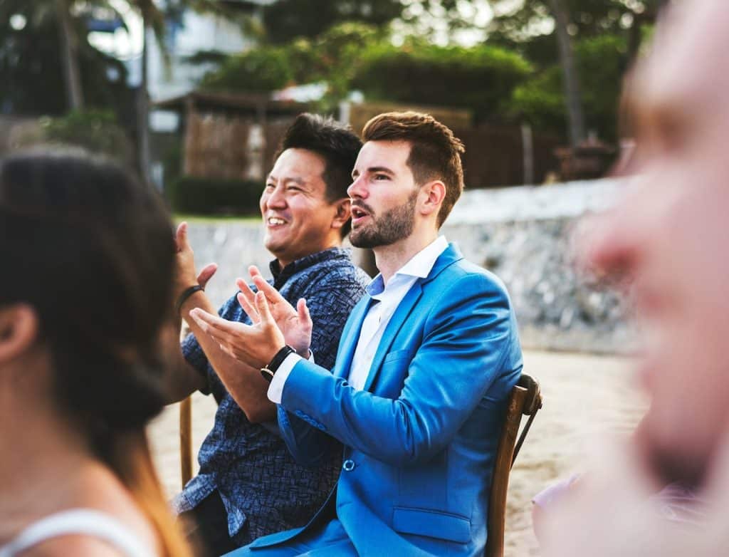 Men clapping for their friends who are getting married.