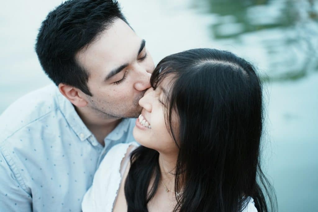 Man kissing a woman on the cheek.