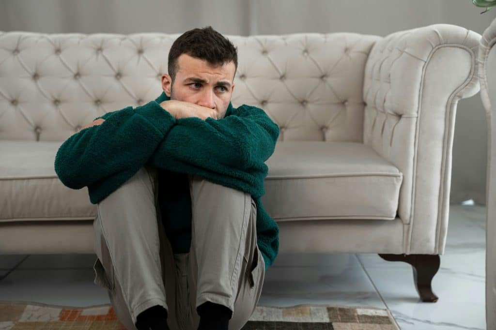A man sitting on the floor