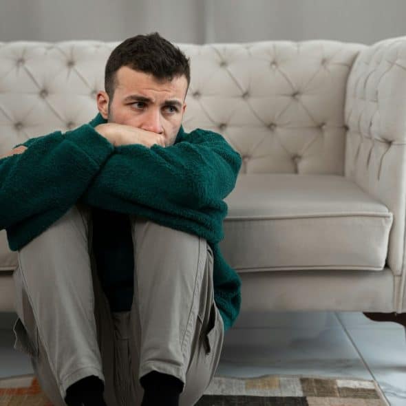 A man sitting on the floor