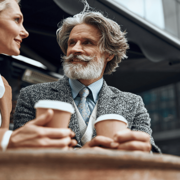 A beautiful mature couple having coffee together