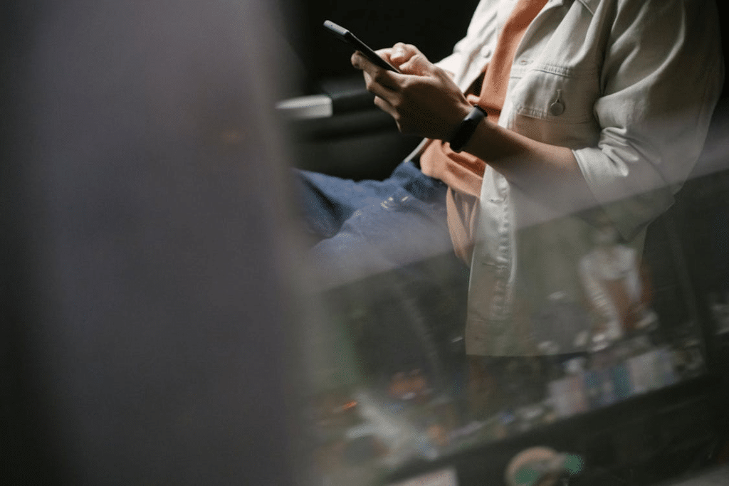 A man texting inside a car
