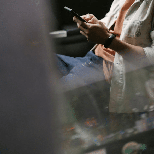 A man texting inside a car