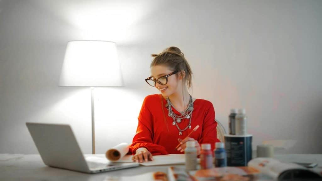 A woman smiling while writing